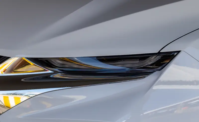 Close view of polished silver paint around a headlight