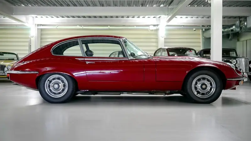 Red classic coupe on a clean studio floor