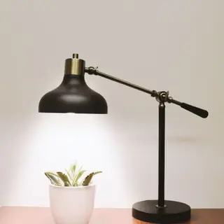 A black desk lamp on a timber table